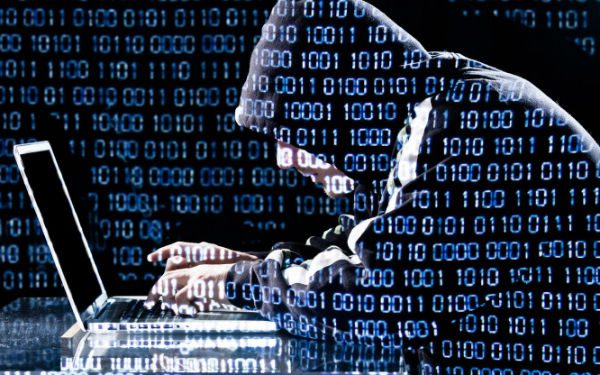 Hacker in a hoodie with code overlayed on image