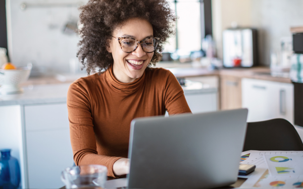 Woman wearing glasses working on her laptop