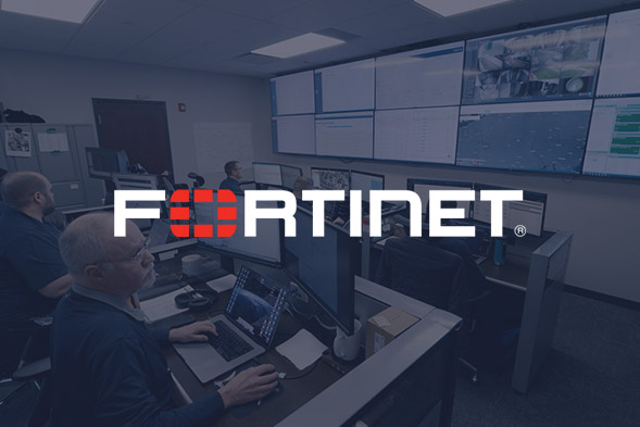 Several people work at computer desks in a control room with large wall-mounted screens displaying data; the Fortinet logo is prominently overlaid on the image.